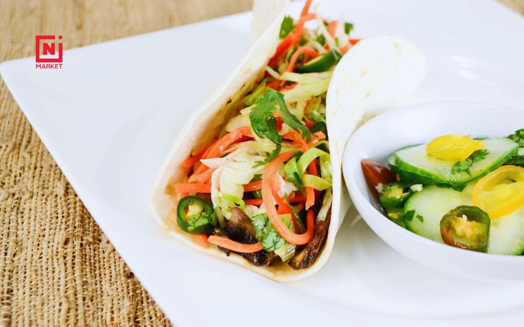 Portobello mushroom tacos are soft tortillas filled with seasoned, cooked portobello slices or strips